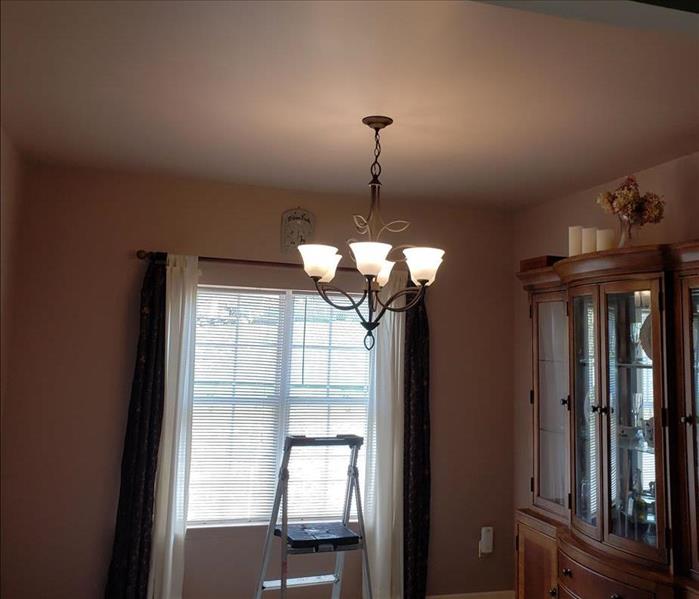 SERVPRO ladder below light fixture in dining room