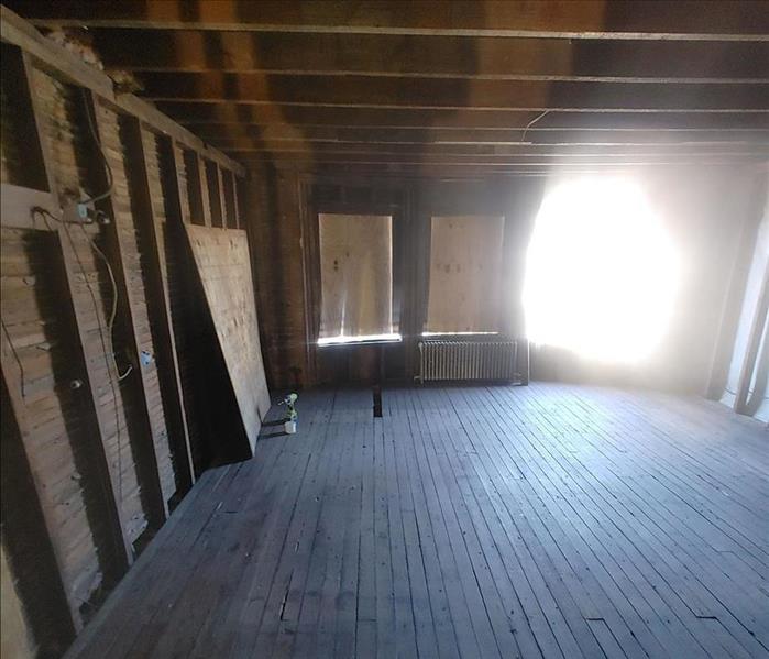 Room with floorboards and framework exposed