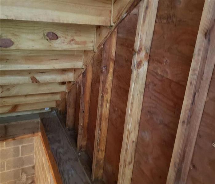  Clean wood studs under stairs in basement
