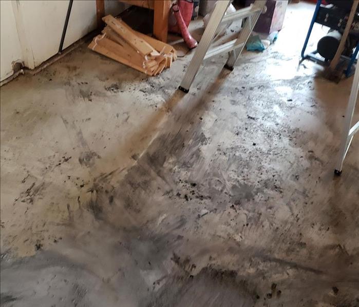 Concrete slab floor with soot spread over it