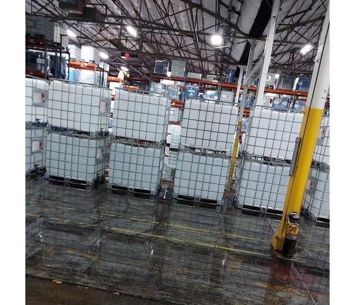 Standing water by full pallets in a warehouse 