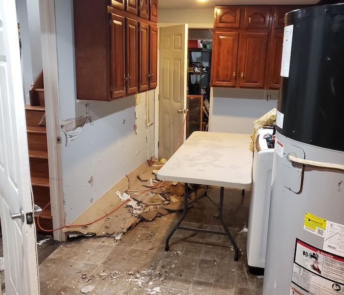 Kitchen with debris on floor with table