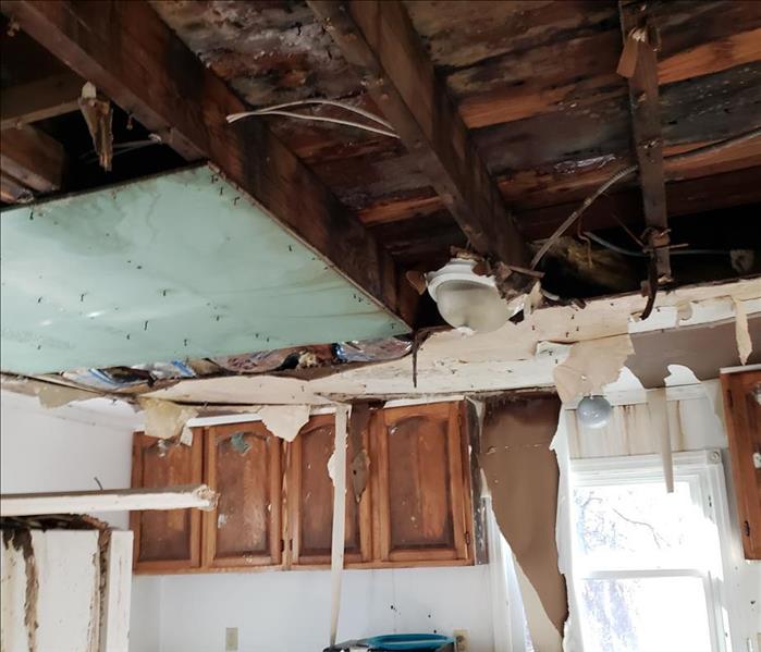 Kitchen with a damaged ceiling over the sink area