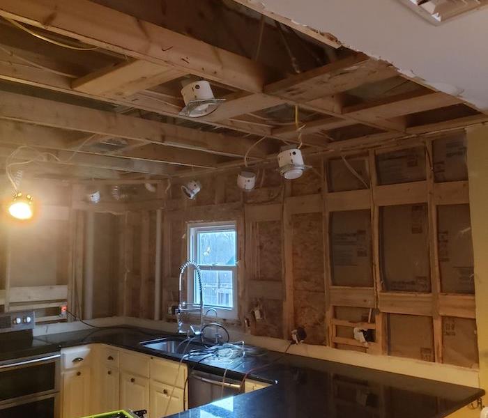 Kitchen with sheetrock removed and framework exposed